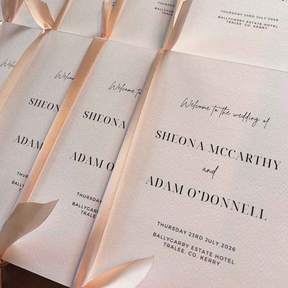 Textured-ceremony-booklet-with-pink-ribbon-