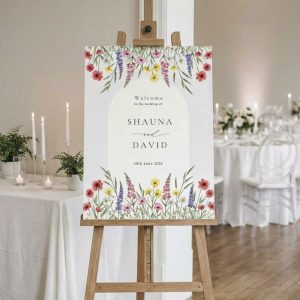 Wildflower themed wedding welcome sign on wooden easel