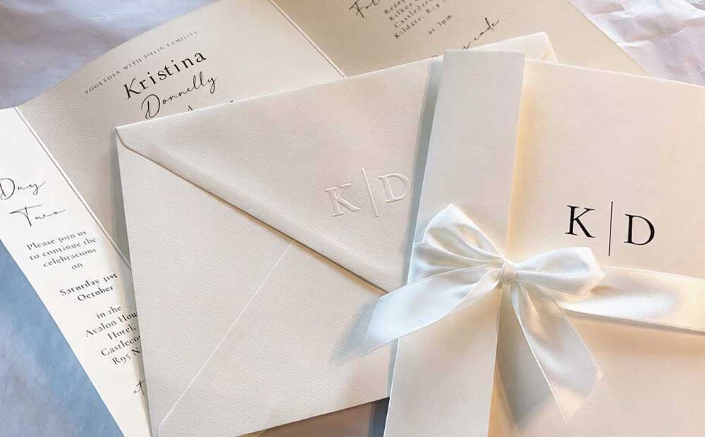 Silk-bow-initials-Monogram-wedding-invitation-close-up Silk-bow-initials-Monogram-wedding-invitation-close-up